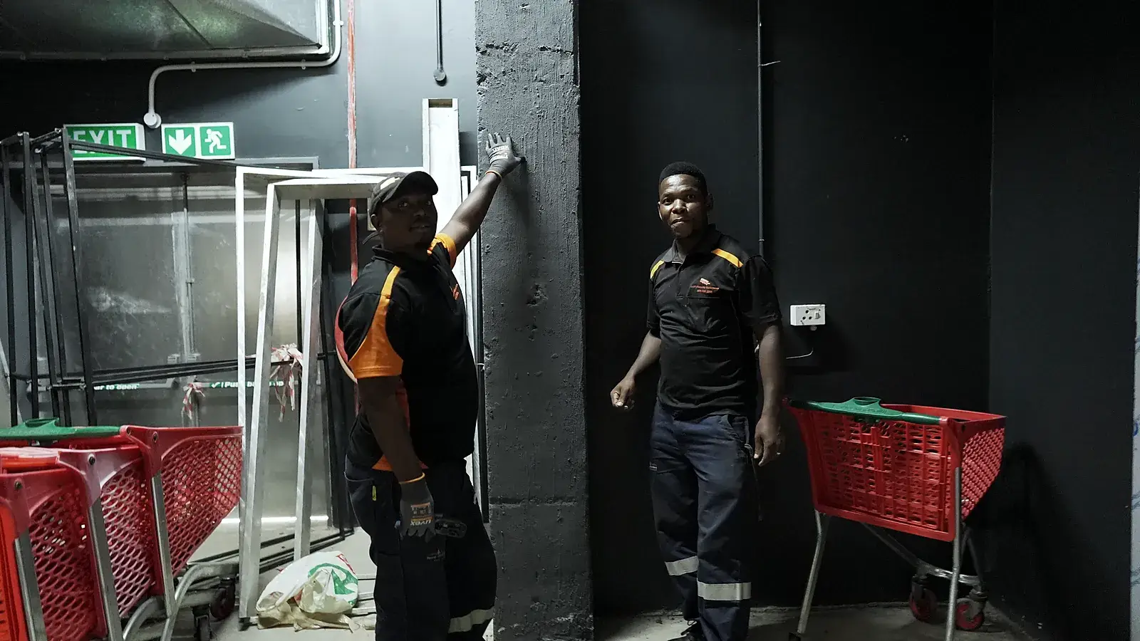 CCTV installation in Germiston, Gauteng: CCTV Security Surveillance technicians fitting equipment at a store's back-of-house exit