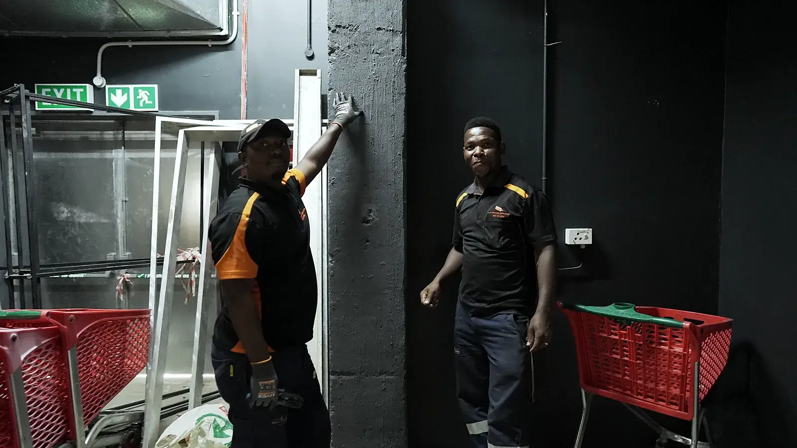 CCTV installation in Krugersdorp, Gauteng: CCTV Security Surveillance technicians fitting equipment at a store's back-of-house exit