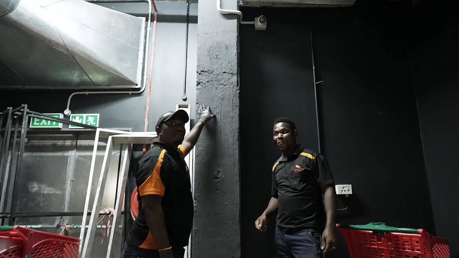 CCTV installation in Ladysmith, KwaZulu-Natal: CCTV Security Surveillance technicians fitting equipment at a store's back-of-house exit