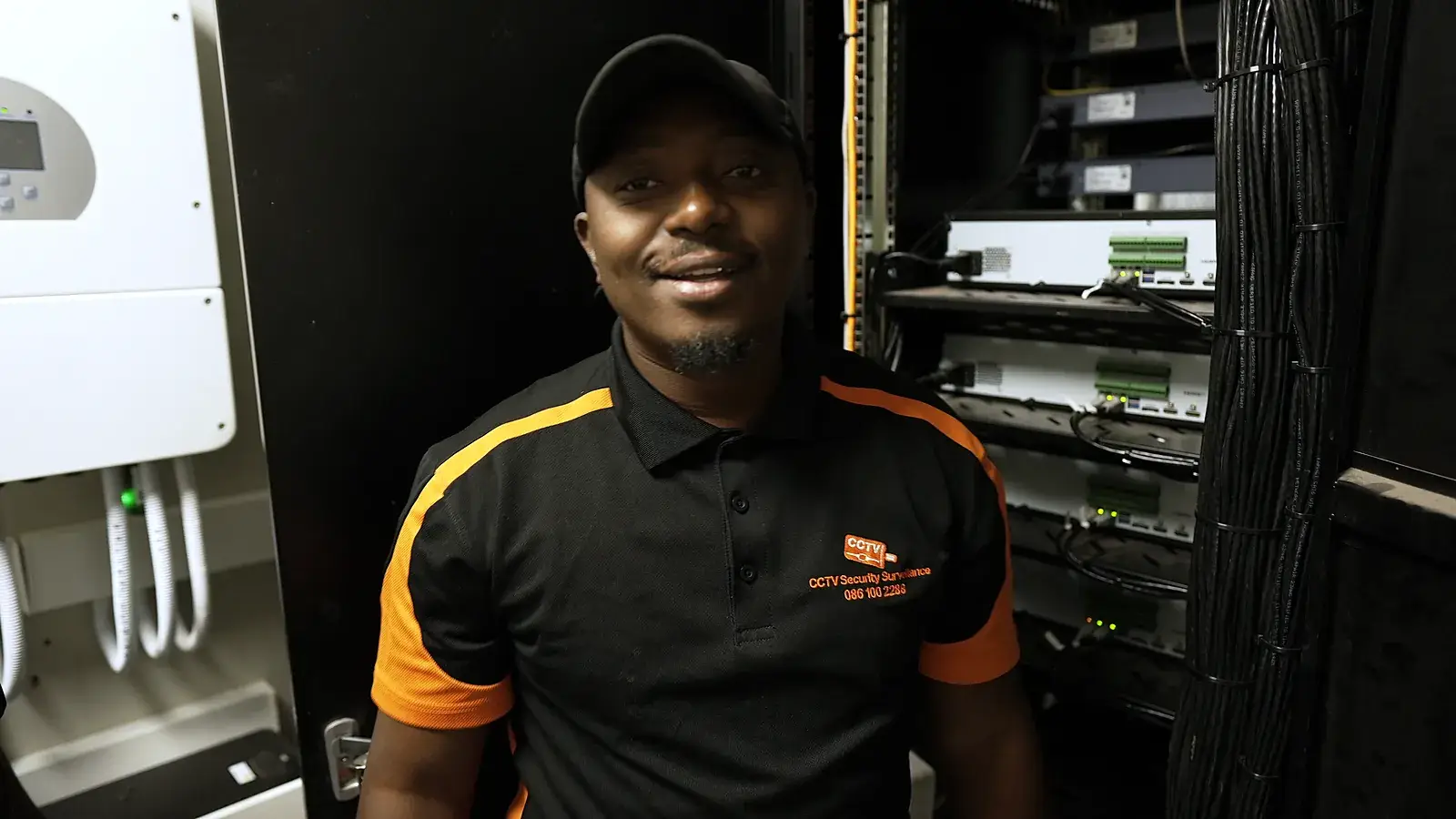 CCTV Security Surveillance technician maintaining a CCTV recorder rack