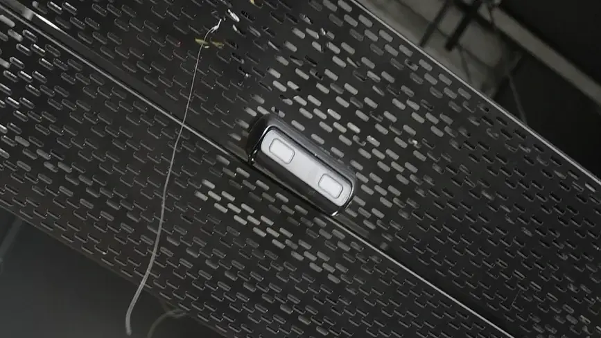 CCTV installation in the Western Cape: close-up of a dual-lens analytics camera mounted on a cable tray under a warehouse roof