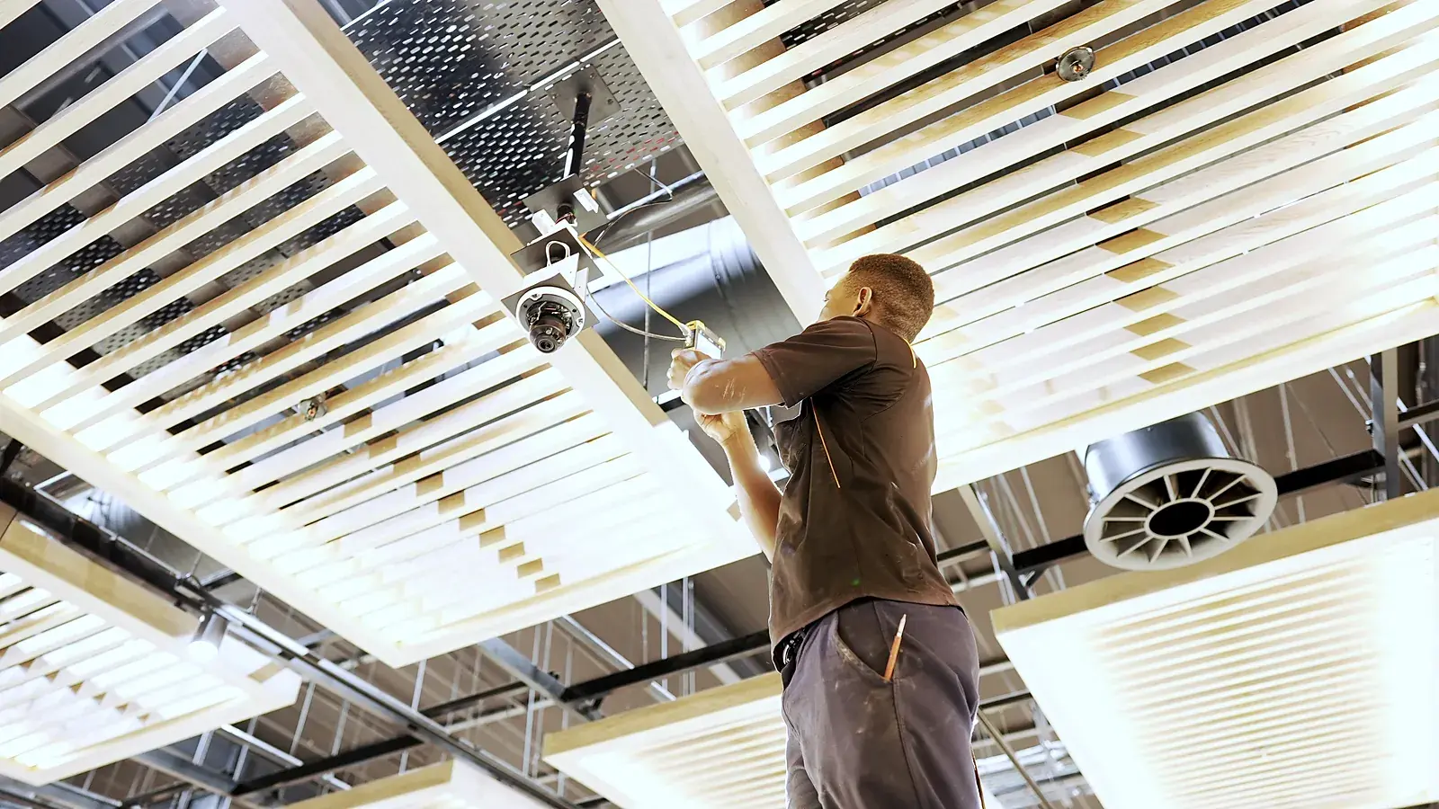 CCTV installation in the Western Cape: CCTV Security Surveillance technician installing a dome camera in a store ceiling