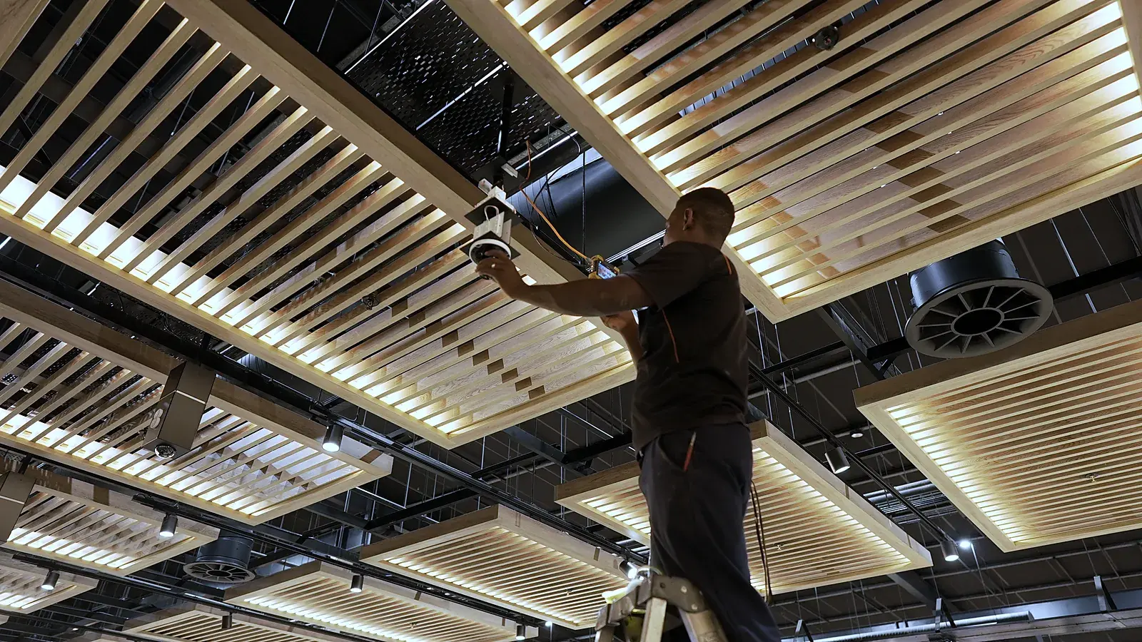 CCTV installation in KwaZulu-Natal: CCTV Security Surveillance technician installing a dome camera in a slatted store ceiling
