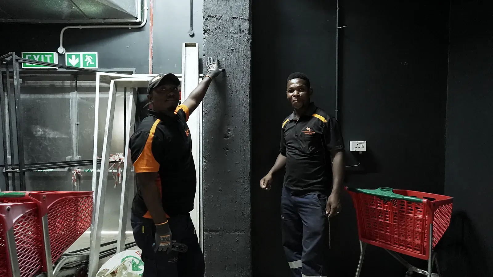 CCTV installation in Krugersdorp, Gauteng: CCTV Security Surveillance technicians fitting equipment at a store's back-of-house exit