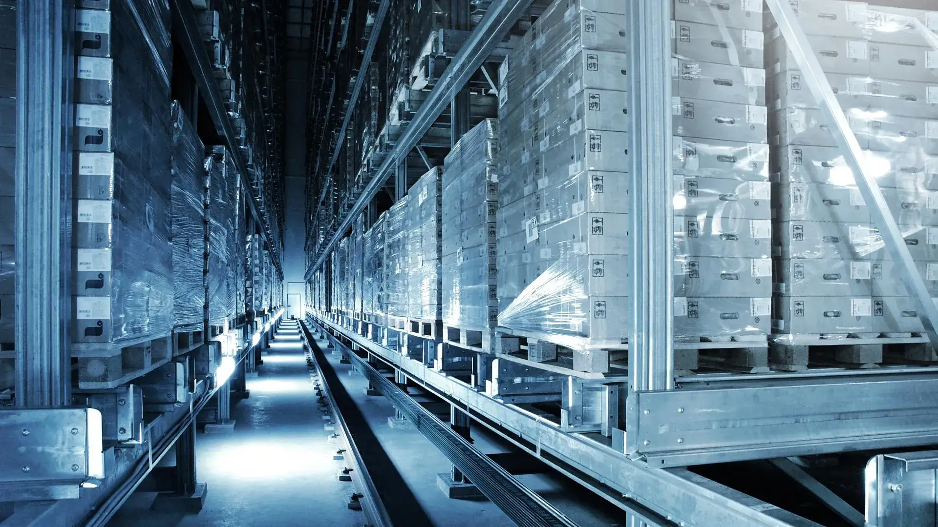 High-bay warehouse aisle stacked with pallets