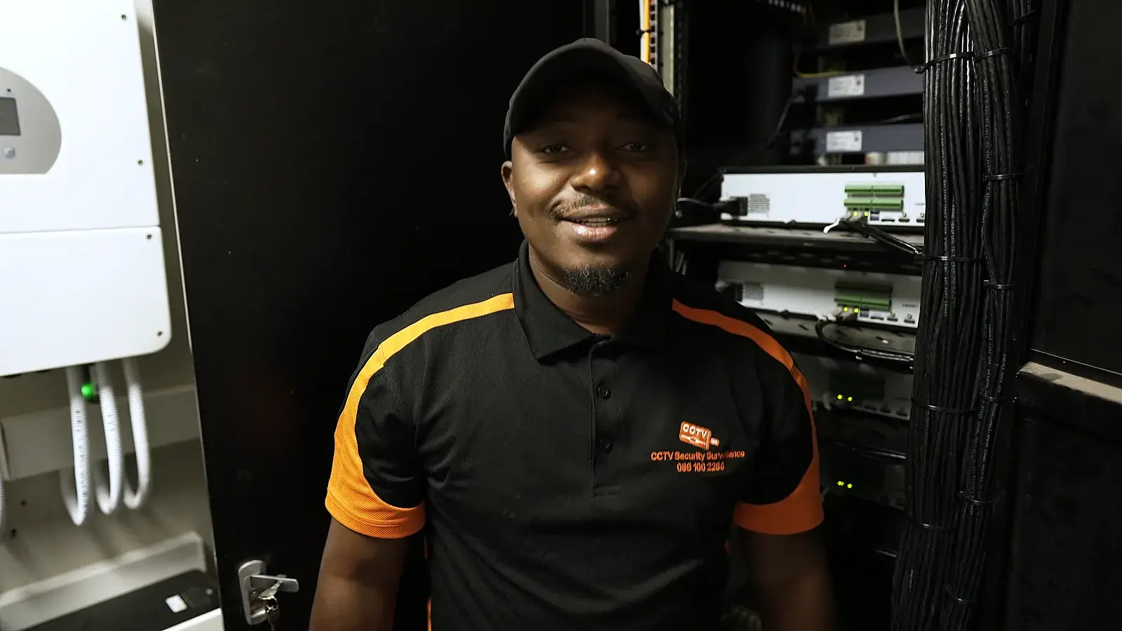 CCTV installation in Alberton, Gauteng: CCTV Security Surveillance technician beside a CCTV recorder rack and backup inverter