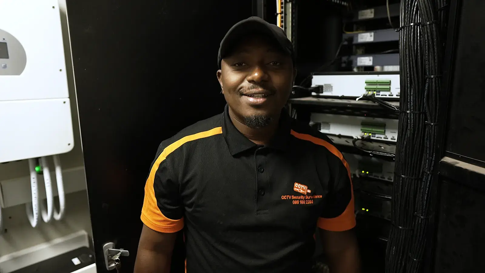 CCTV installation in Alberton, Gauteng: CCTV Security Surveillance technician beside a CCTV recorder rack and backup inverter