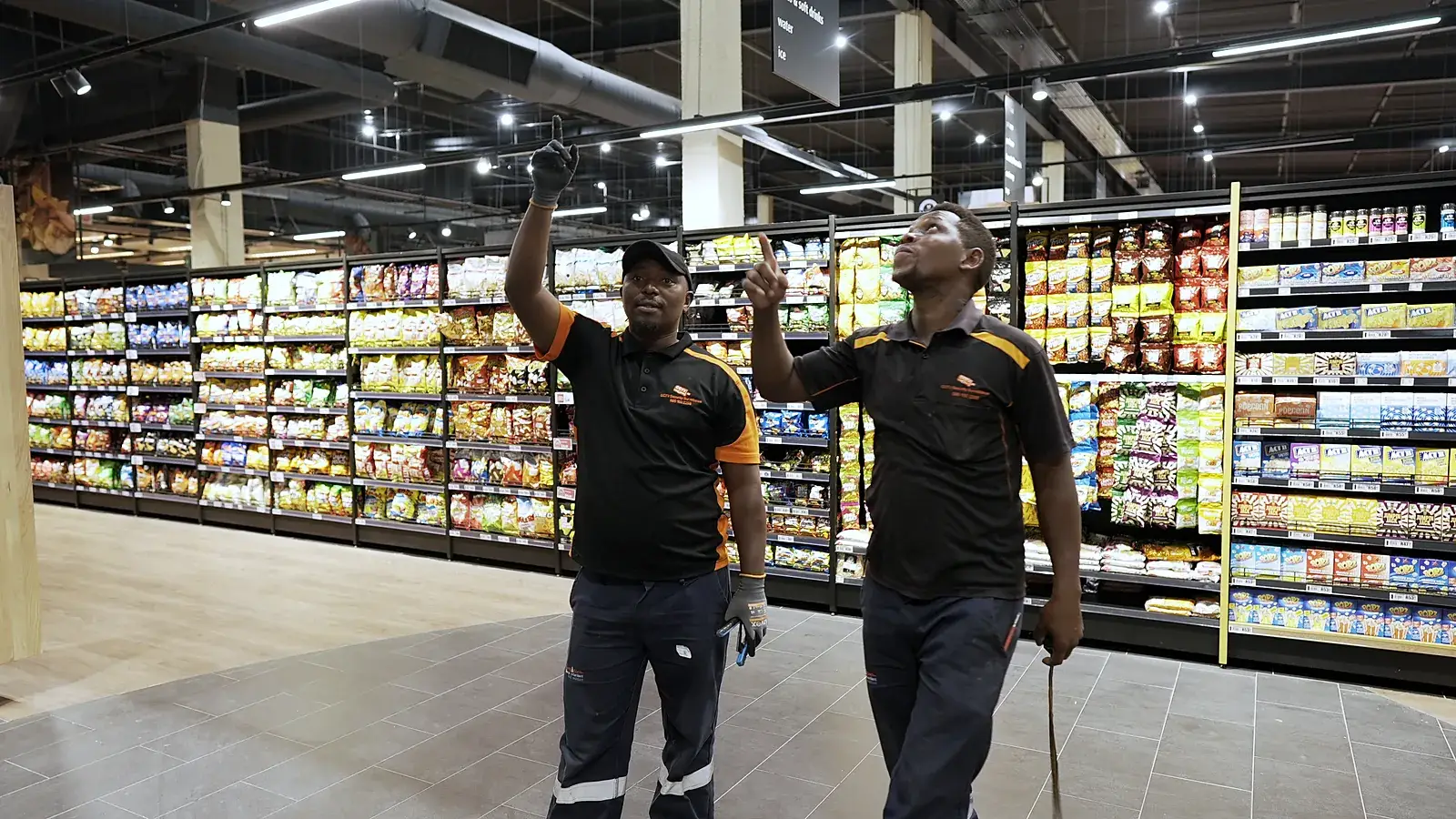 CCTV installation in Centurion, Gauteng: CCTV Security Surveillance technicians checking camera coverage in a store aisle