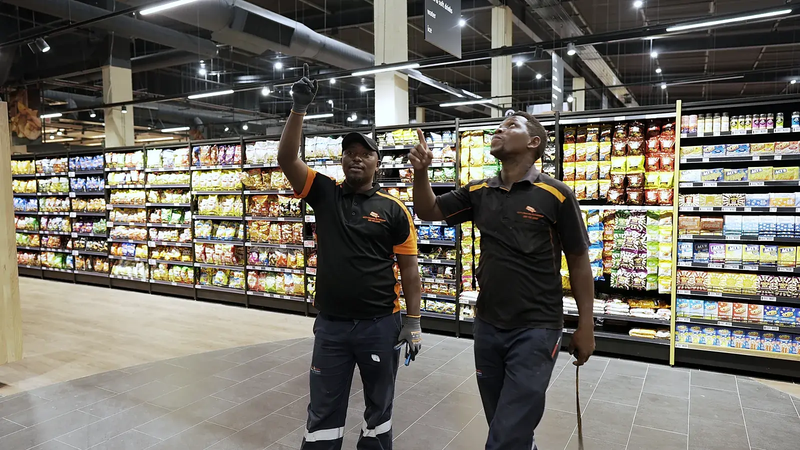 CCTV installation in Centurion, Gauteng: CCTV Security Surveillance technicians checking camera coverage in a store aisle