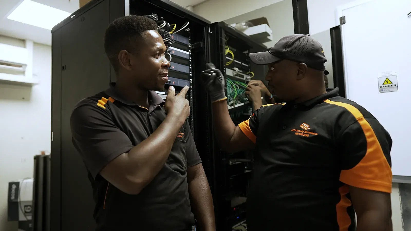 CCTV installation in Kempton Park, Gauteng: CCTV Security Surveillance technicians wiring a CCTV network cabinet