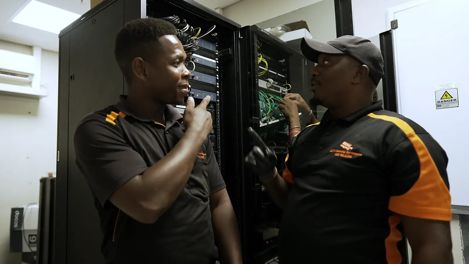 CCTV installation in Montague Gardens, Western Cape: CCTV Security Surveillance technicians wiring a CCTV network cabinet