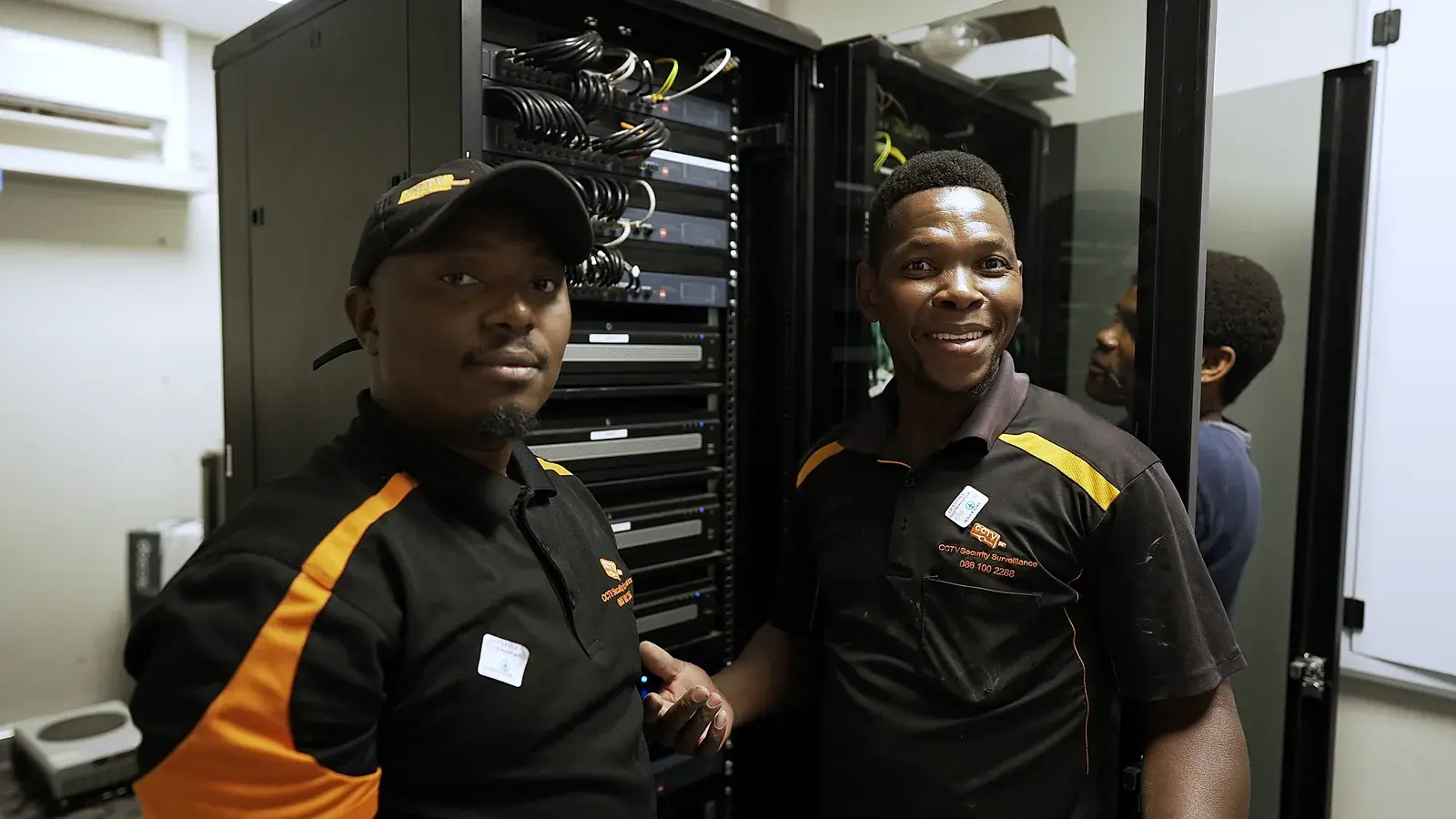 CCTV installation in Randburg, Gauteng: CCTV Security Surveillance technicians at a CCTV network cabinet they installed