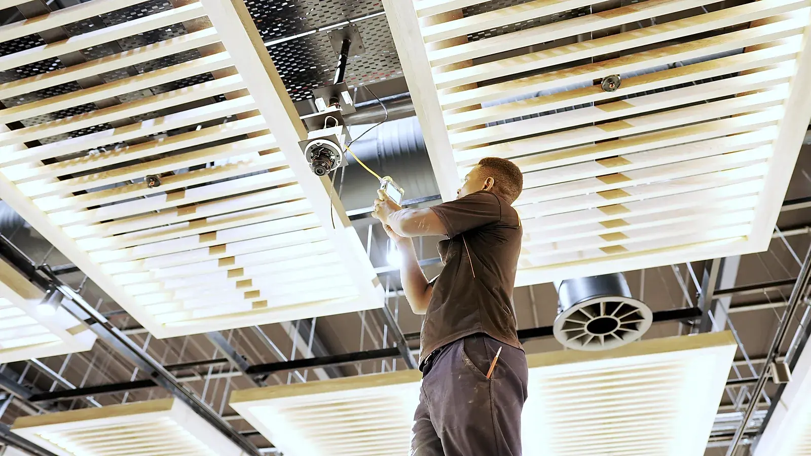CCTV installation in Stellenbosch, Western Cape: CCTV Security Surveillance technician installing a ceiling dome camera