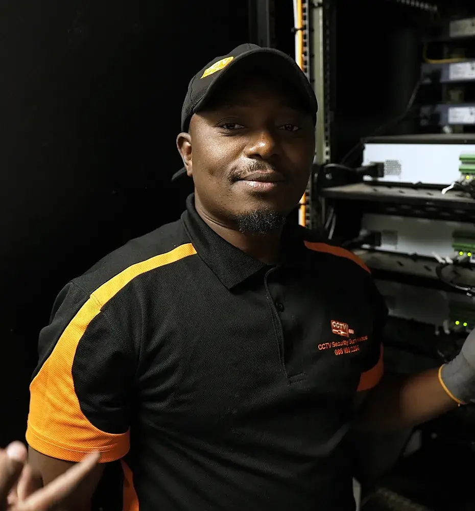 CCTV Security Surveillance technician beside a CCTV recorder rack and backup inverter