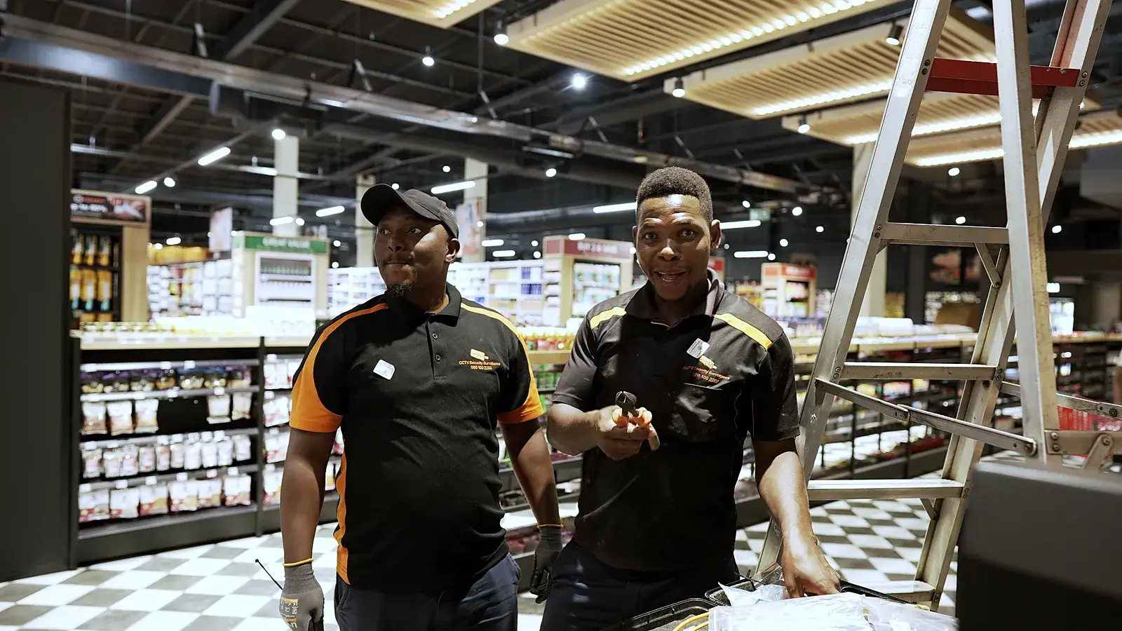 CCTV Security Surveillance installation team on a retail store floor